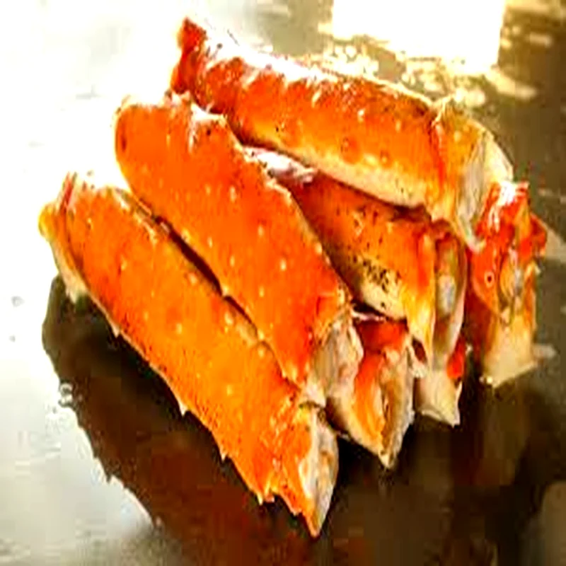 Premium frozen king crab merus sections with rich orange shell and thick white meat, prepared for wholesale seafood distribution.