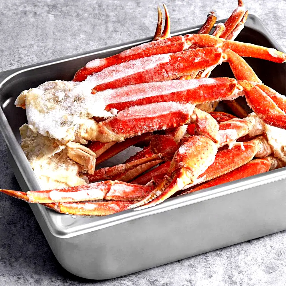 Frozen snow crab legs with ice crystals ready for wholesale seafood export