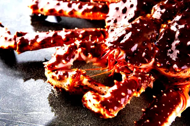Live Norwegian red king crab close-up showing shell texture and legs, premium seafood export quality