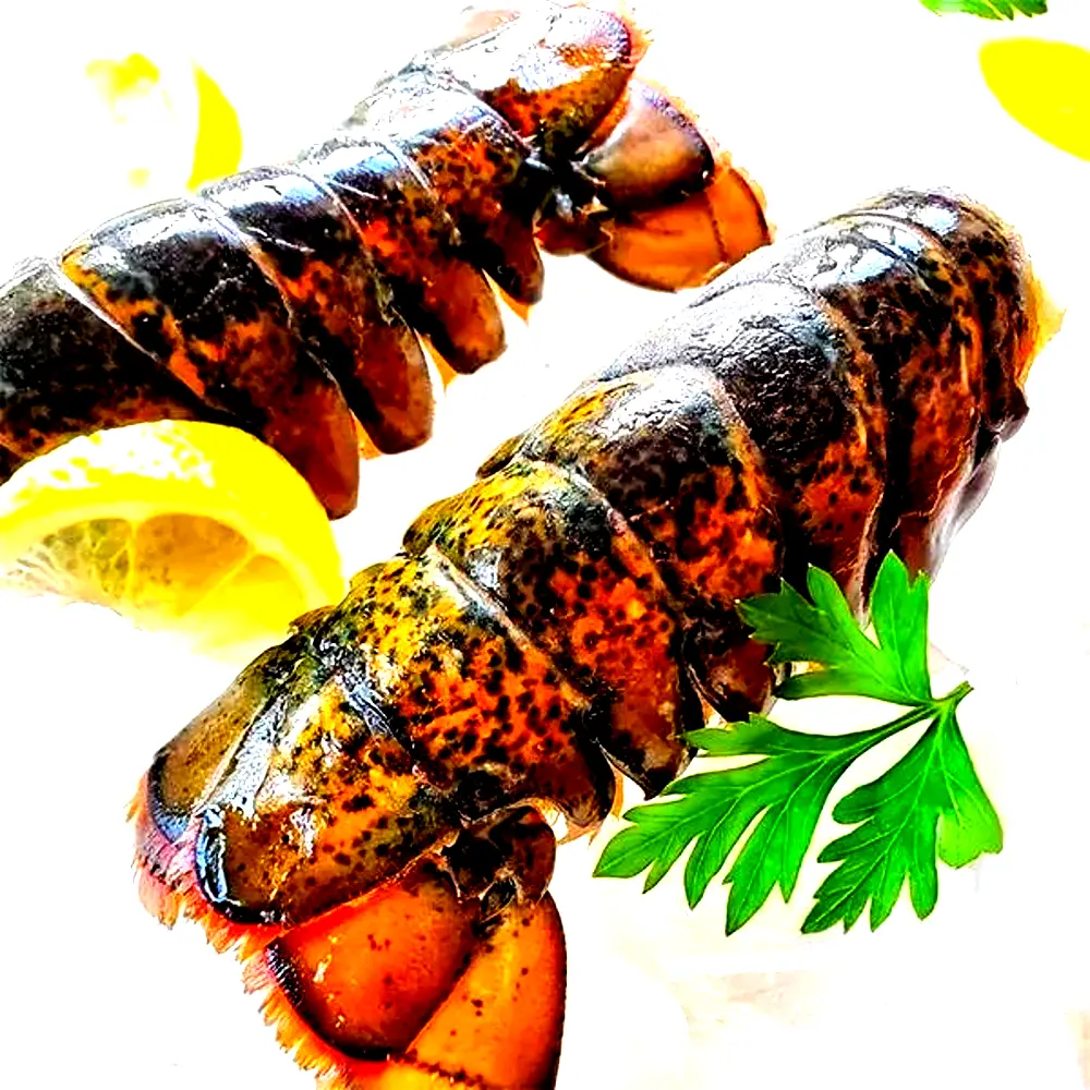 Fresh lobster tails on ice with lemon and parsley for premium seafood presentation